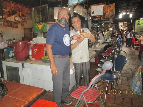 Coffee seller and visitor at Phnom Penh’s Russian Market